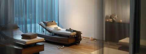 two lounge chairs mounted on wooden platforms. They are adjustable for the angle that is most comfortable. There is a reading light next to the chairs. Each chair has a blanket and pillow.