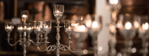 detail shot of a candelabra. There is one central candle holder with four surrounding it.