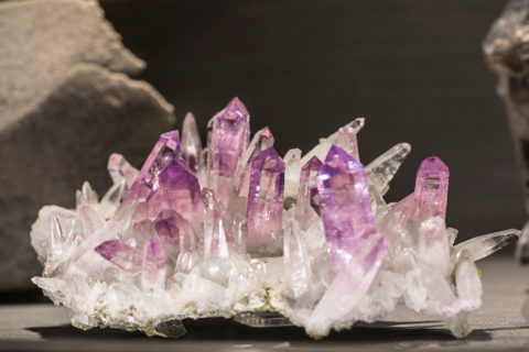 a detail shot of a jagged crystal formation on display at the Belle Epoque museum at the resort. The crystal is clear white at the bottom and gradually becomes purple at the top of each crystal formation.