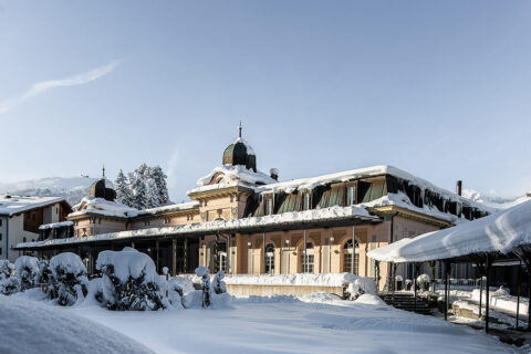 snow covered Belle Epoque pavilion, snow covered grounds and trees, big clear blue sky background